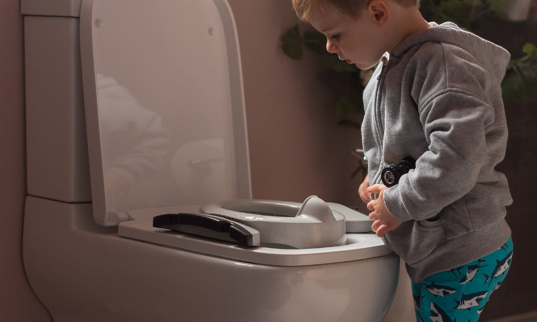 Child looking at toilet