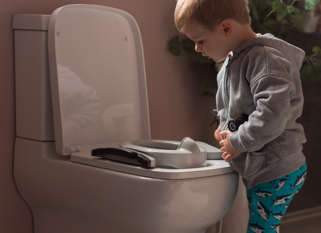 Child looking at toilet